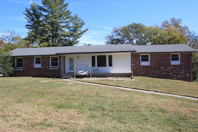 ranch-style home with a front yard and covered porch