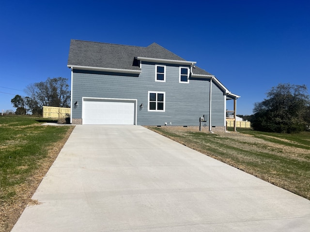 view of front of property with a front lawn and a garage