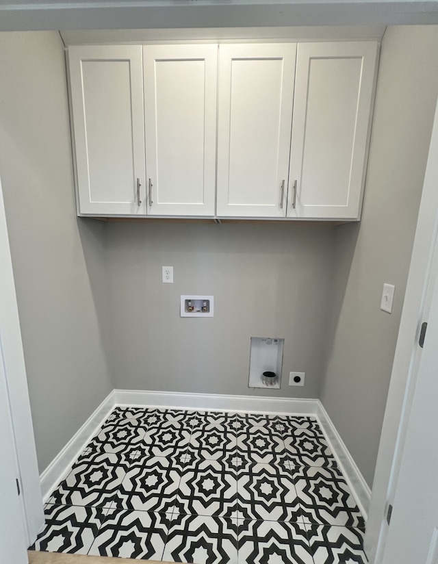 laundry room featuring tile patterned floors, washer hookup, hookup for an electric dryer, and cabinets