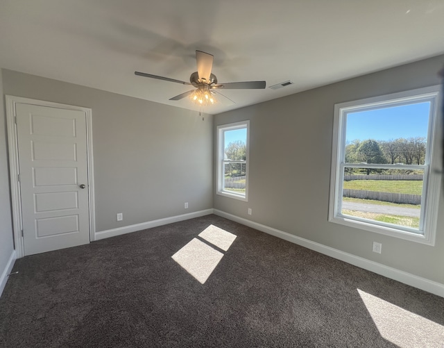 carpeted spare room featuring ceiling fan