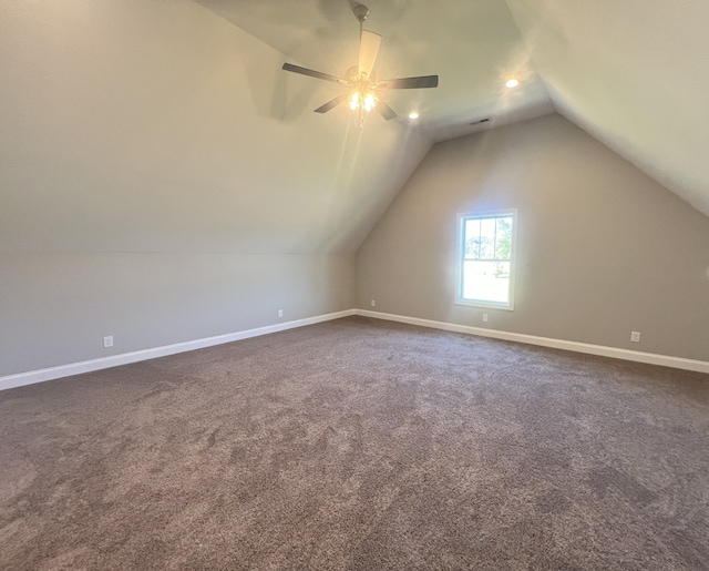 bonus room featuring ceiling fan, vaulted ceiling, and dark carpet