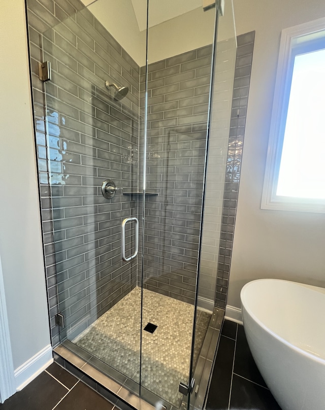 bathroom with tile patterned floors, lofted ceiling, and separate shower and tub