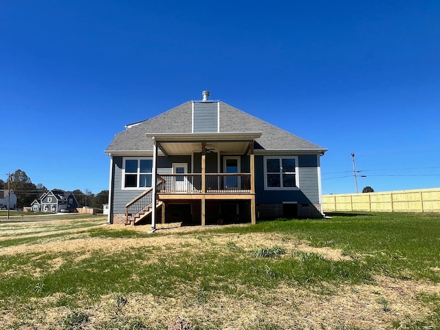 back of property featuring a deck and a yard