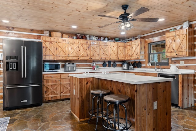 kitchen featuring a center island, appliances with stainless steel finishes, sink, and ceiling fan