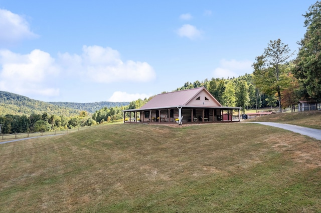 cabin with a mountain view and a front lawn