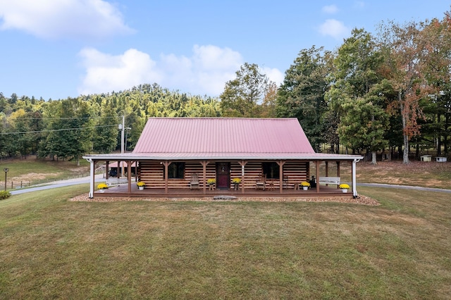 cabin with a front yard and covered porch