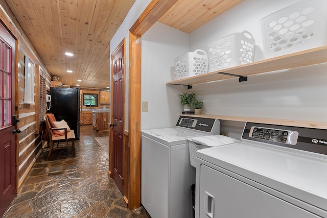 laundry room with wooden ceiling and washing machine and dryer