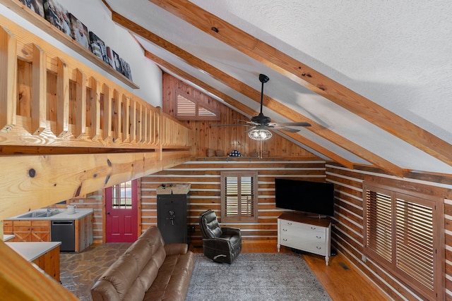 living room with beamed ceiling, hardwood / wood-style flooring, wooden walls, and a wealth of natural light