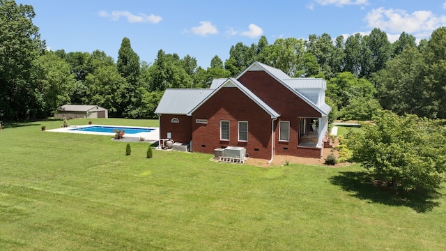 rear view of property featuring a patio area and a lawn