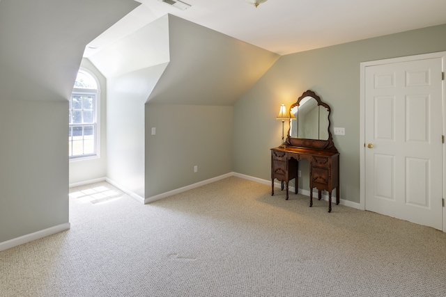 additional living space with light carpet and lofted ceiling