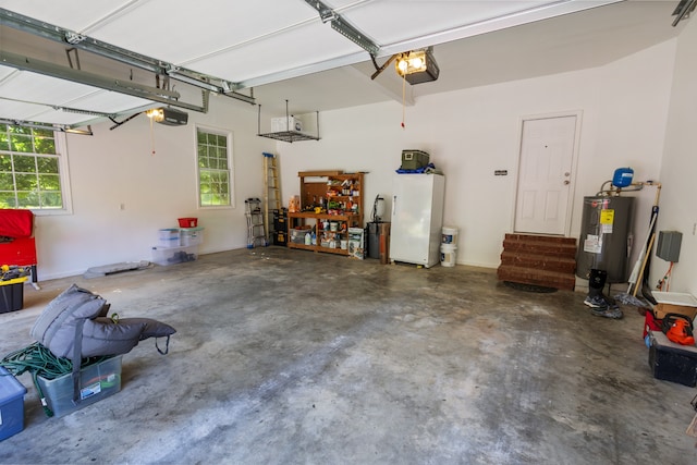 garage featuring a garage door opener, electric water heater, and white refrigerator