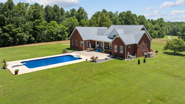 back of property with a patio area, a lawn, and central AC unit