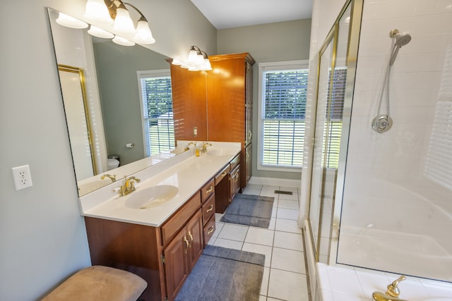 bathroom with vanity, a shower with shower door, toilet, and tile patterned flooring