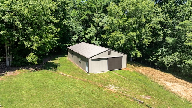 view of outbuilding featuring a lawn and a garage