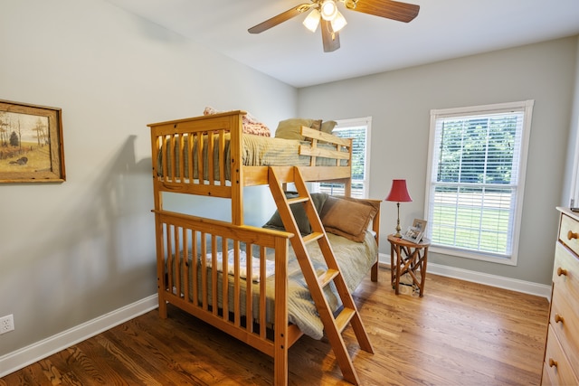 bedroom with dark wood-type flooring and ceiling fan