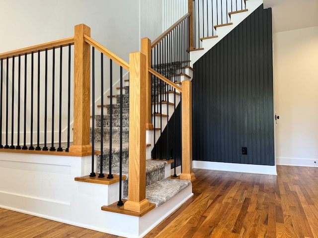 stairs featuring hardwood / wood-style flooring