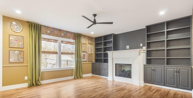 unfurnished living room with ceiling fan and light hardwood / wood-style floors