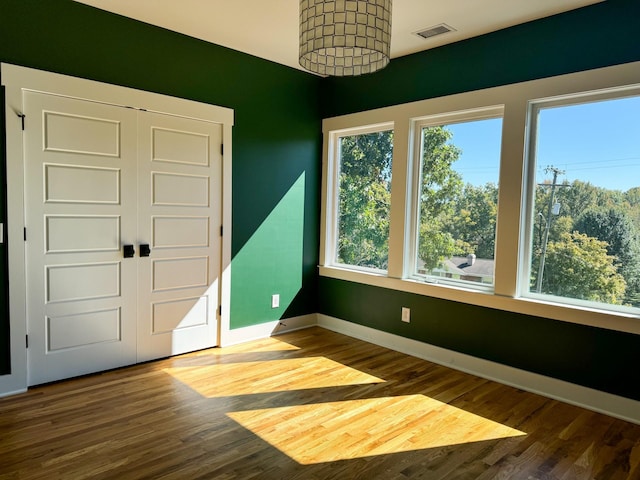 unfurnished room featuring wood-type flooring