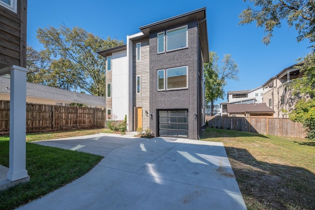 exterior space featuring a patio, a yard, and a garage