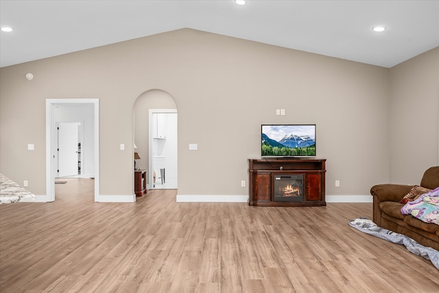 unfurnished living room featuring light hardwood / wood-style flooring and vaulted ceiling