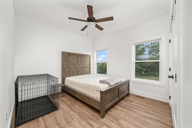 bedroom featuring light hardwood / wood-style floors and ceiling fan