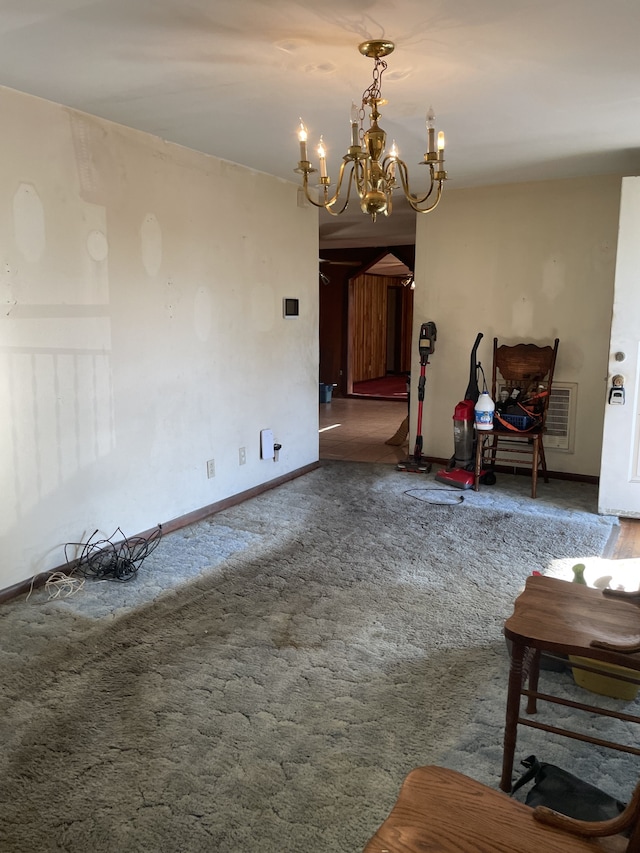 unfurnished living room with a chandelier and dark colored carpet