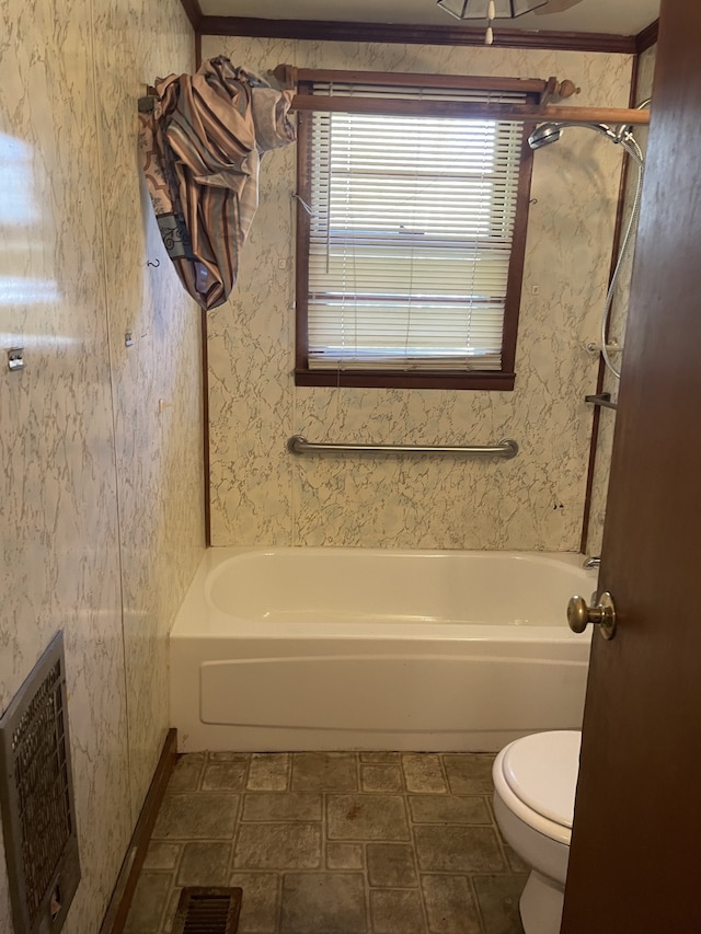 bathroom with toilet and bathtub / shower combination