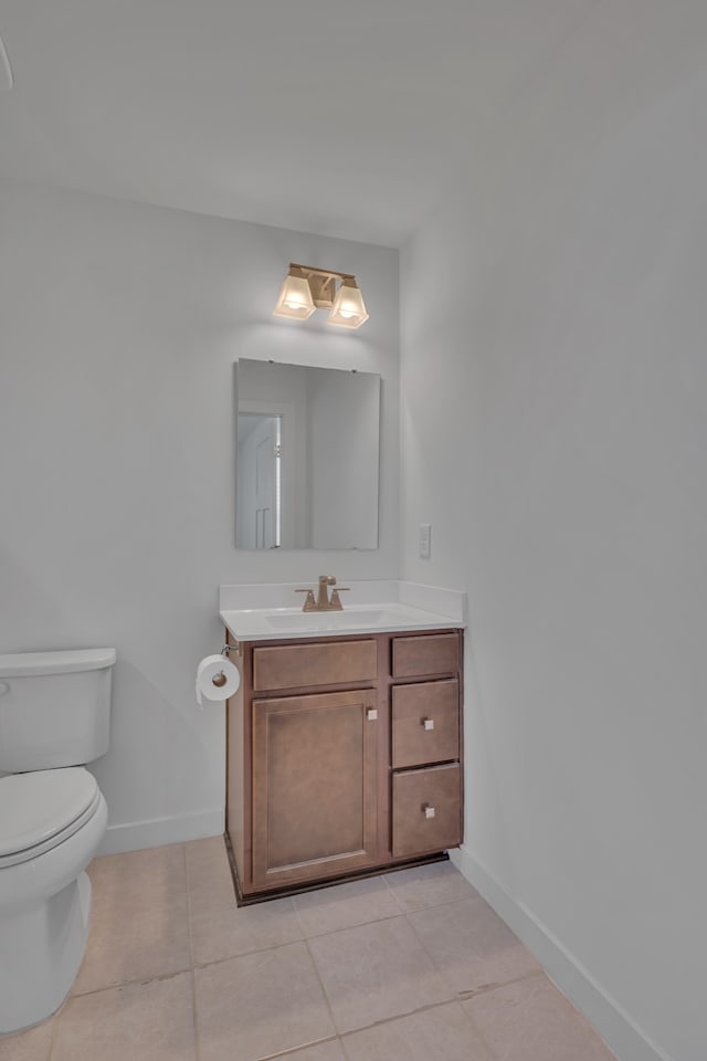 bathroom featuring toilet, vanity, and tile patterned floors