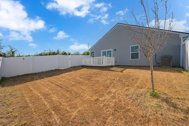 view of yard featuring central AC unit and a deck