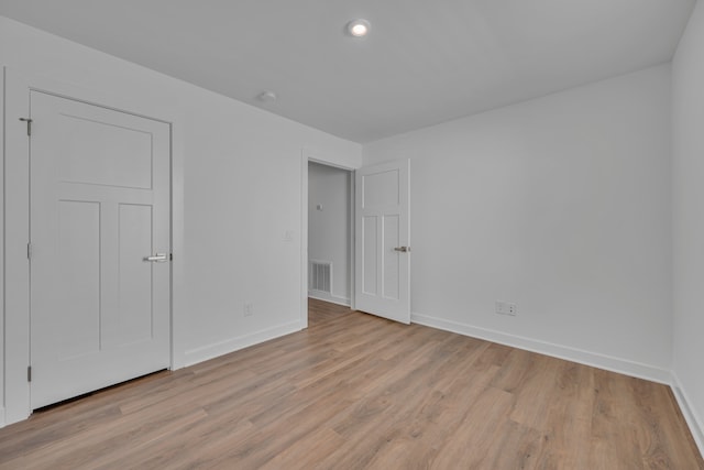 unfurnished bedroom featuring light wood-type flooring