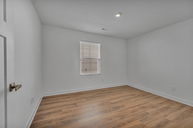 spare room featuring hardwood / wood-style floors