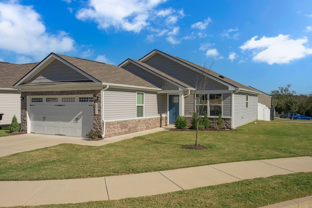 craftsman house featuring a front yard and a garage