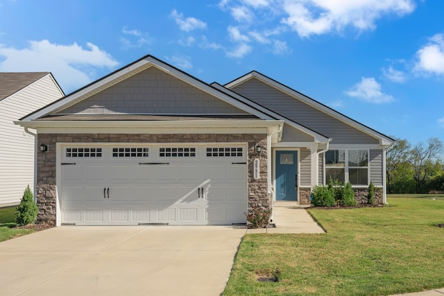 craftsman-style home featuring a front lawn and a garage