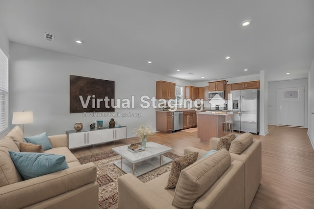 living room with plenty of natural light and light wood-type flooring