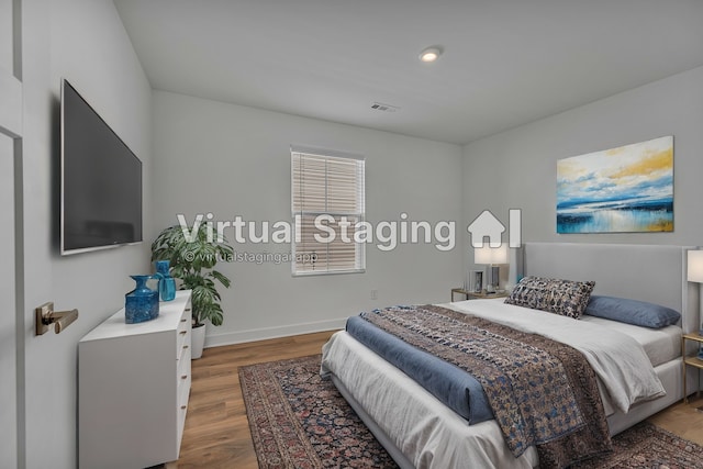 bedroom with dark hardwood / wood-style flooring