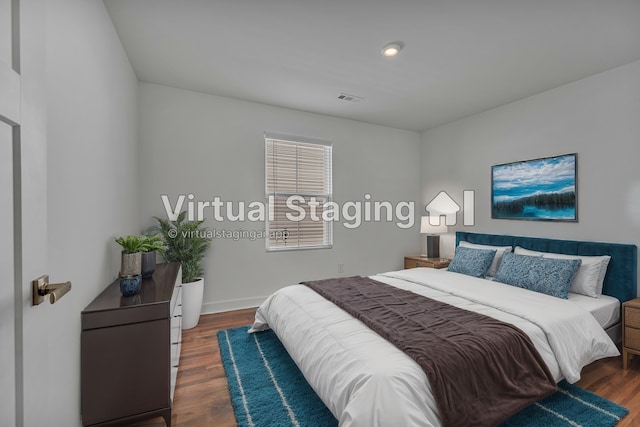 bedroom with dark hardwood / wood-style floors