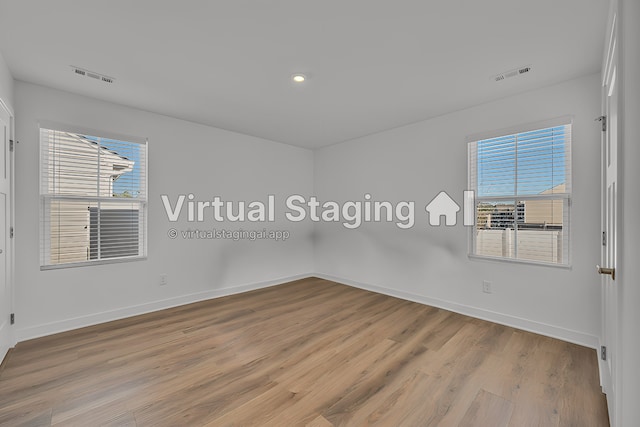 spare room featuring light hardwood / wood-style floors