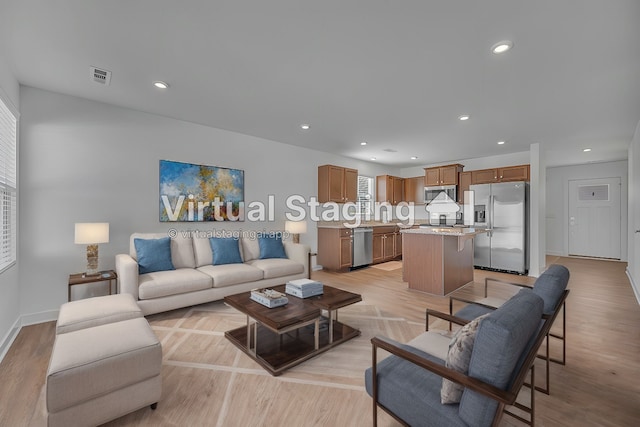 living room featuring light hardwood / wood-style floors and plenty of natural light