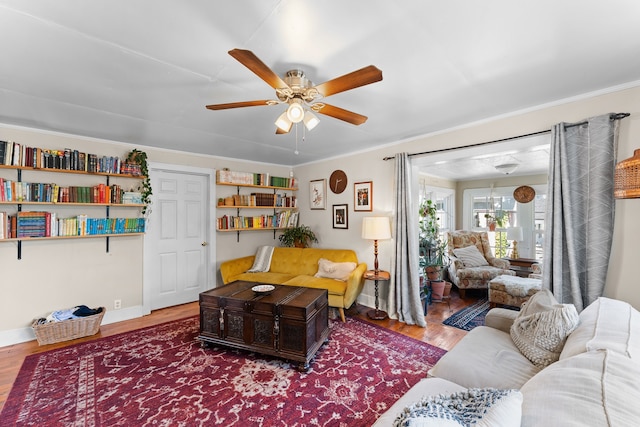 living room featuring hardwood / wood-style floors and ceiling fan