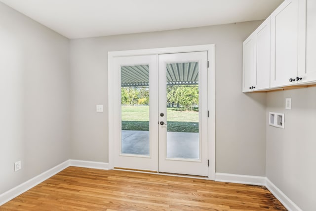 interior space featuring cabinets, french doors, washer hookup, and light wood-type flooring