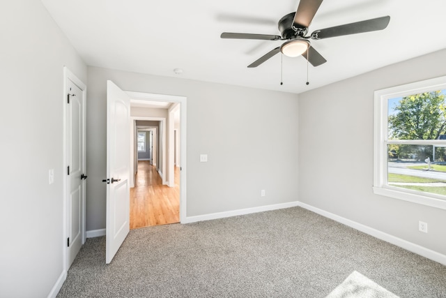 carpeted empty room featuring ceiling fan