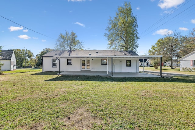 rear view of house with a patio area and a lawn