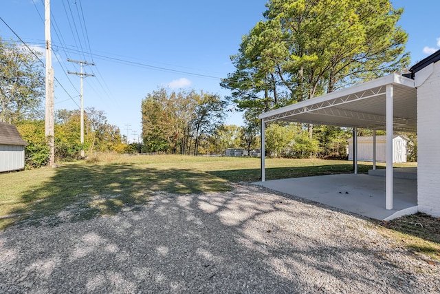 view of yard with a shed and a carport