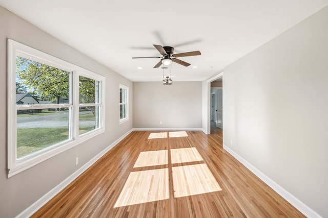 spare room with light hardwood / wood-style flooring and ceiling fan