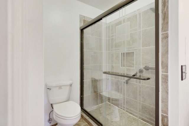 bathroom featuring toilet and walk in shower