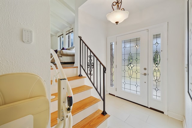 entrance foyer featuring beam ceiling