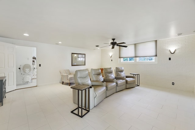 tiled living room featuring brick wall and ceiling fan