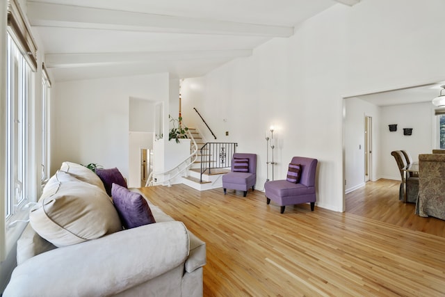 living room with lofted ceiling with beams and hardwood / wood-style floors