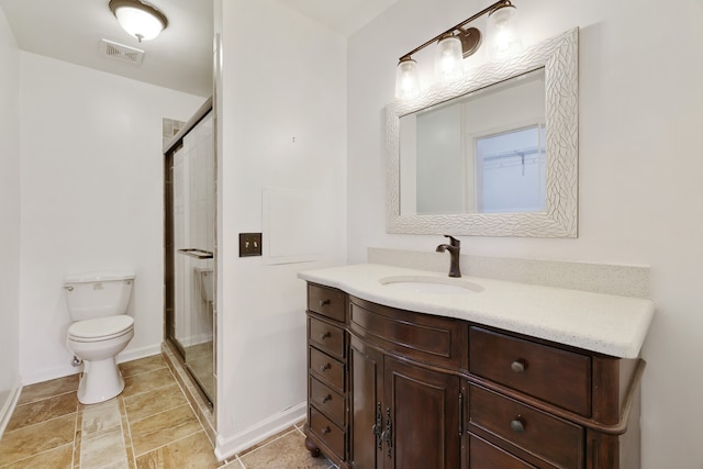 bathroom featuring vanity, toilet, and an enclosed shower