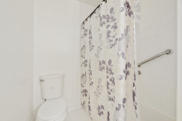 bathroom featuring toilet, tile patterned floors, and a shower with curtain